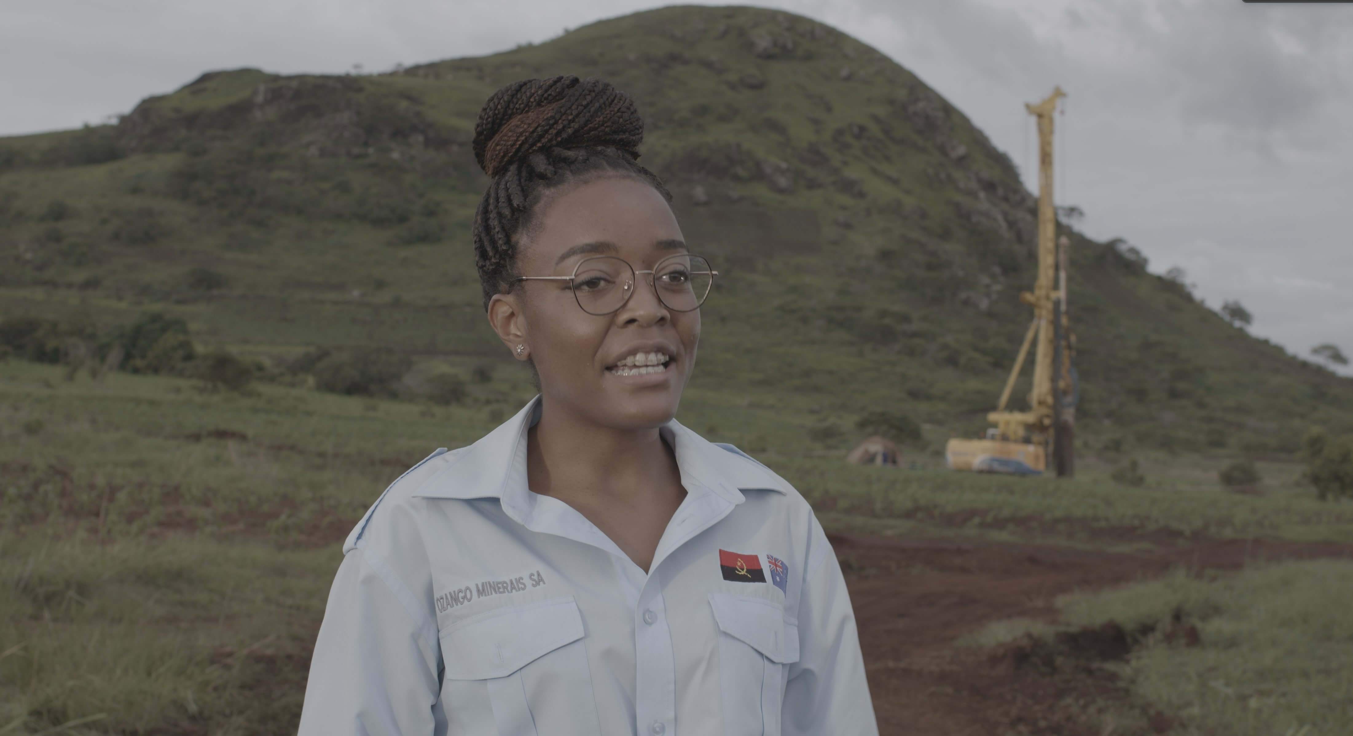 woman being interviewed with a field in the background